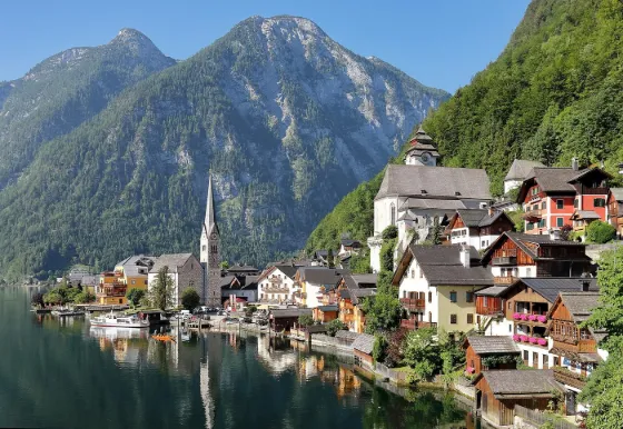 The village of Hallstatt on the shore of Lake Hallstatt, with its church spire and wooden houses beneath steep Alpine peaks