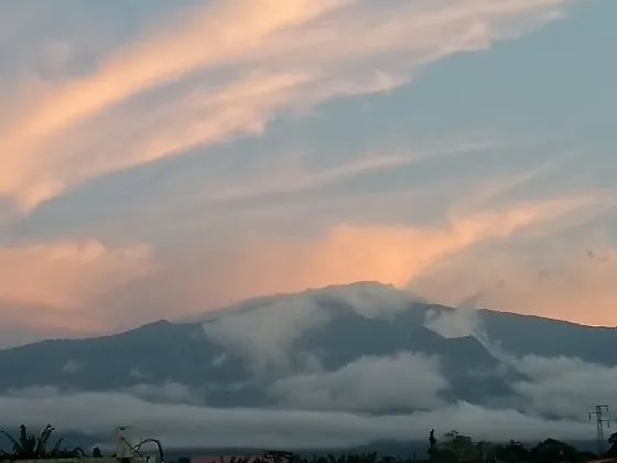 Cloud banked against the forested volcanic slopes of Bioko island at dusk, Equatorial Guinea