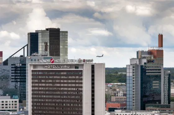 Glass and concrete office towers of central Tallinn rising under a cloudy sky, Estonia