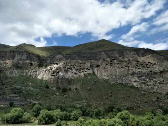 Rows of rock-cut cave dwellings of the Vardzia monastery honeycombing a steep cliff face in southern Georgia
