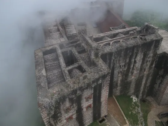 The stone ramparts of the Citadelle Laferriere on its mountain ridge in northern Haiti, seen from the air through haze