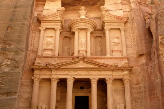 Al-Khazneh (the Treasury), an ornate facade carved into rose-colored sandstone cliffs at Petra