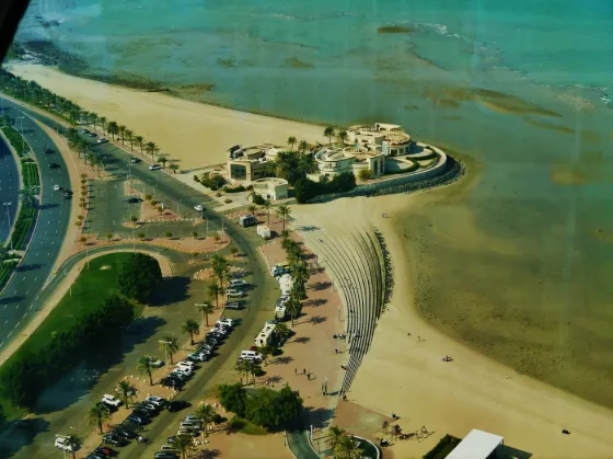 The Kuwait Towers and a curving coastal road seen from above, with the Gulf beyond, Kuwait City