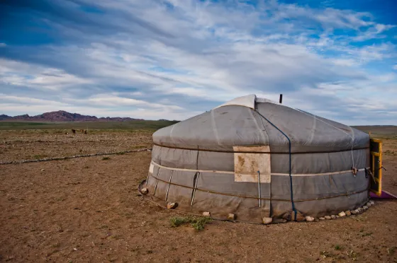 Traditional white gers (yurts) scattered across the open Mongolian steppe