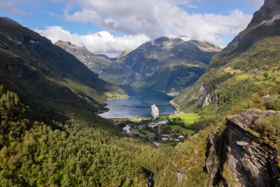 Geirangerfjord, a narrow fjord with steep green mountainsides and waterfalls in western Norway
