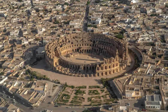 The oval Roman amphitheatre of El Jem seen from the air, ringed by the low rooftops of the surrounding town, Tunisia
