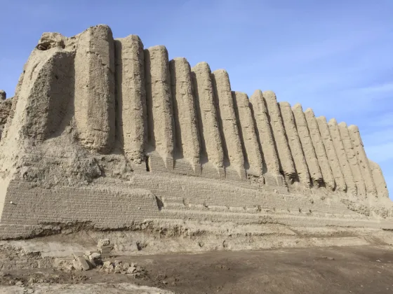 The corrugated mud-brick walls of the Greater Kyz Kala fortress at Merv standing against a blue sky, Turkmenistan