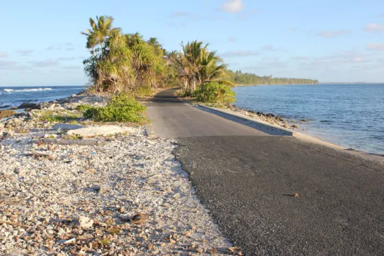 A narrow strip of road and land on Funafuti with the sea close on both sides, Tuvalu