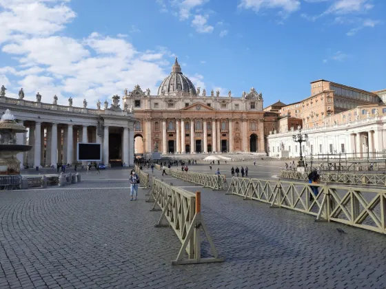 The colonnade and dome of St Peter's Basilica across the cobbles of St Peter's Square, Vatican City